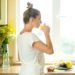 portrait-attractive-woman-drinking-juice-kitchen