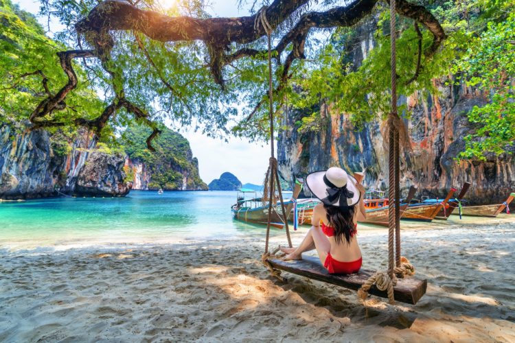 Woman-in-bikini-relaxing-on-swing